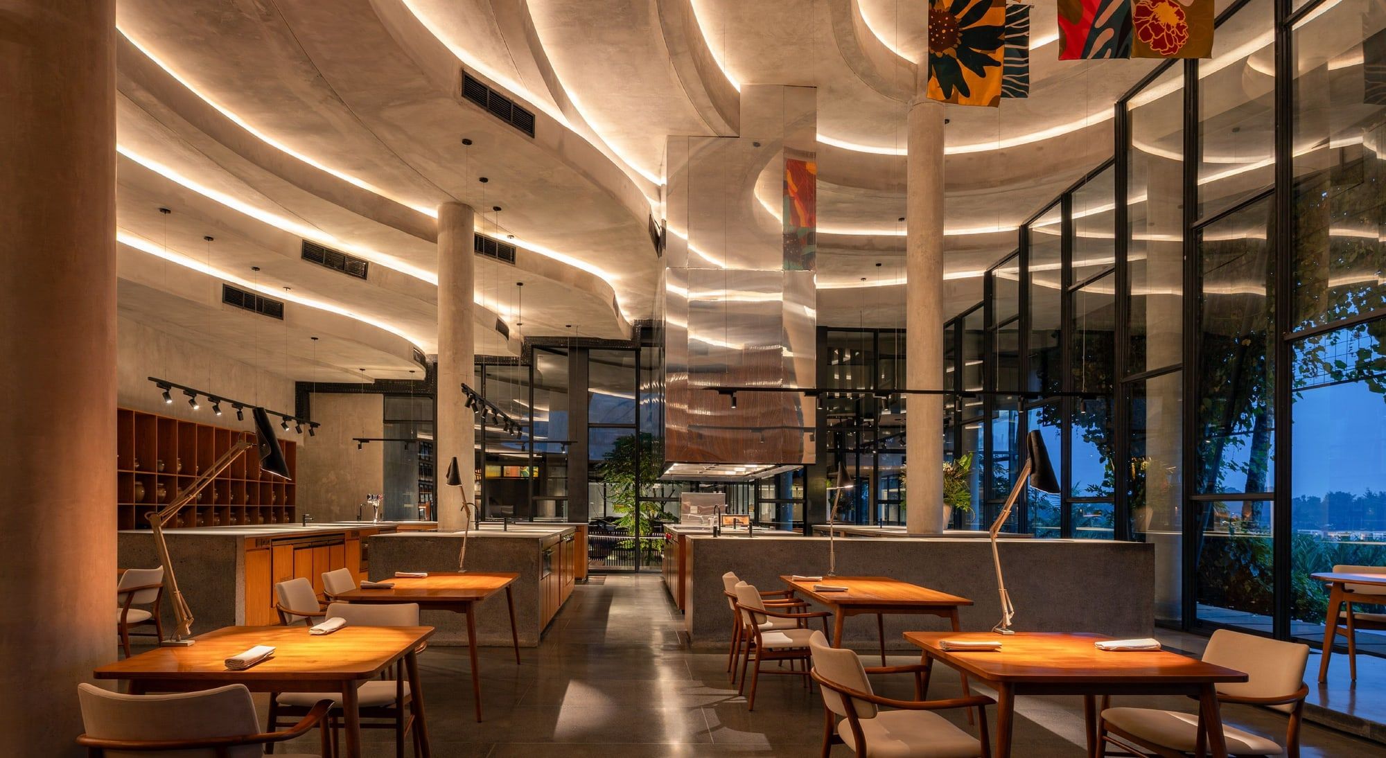 The curved dining room at Locavore NXT, lit warmly, with tables set for the tasting menu
