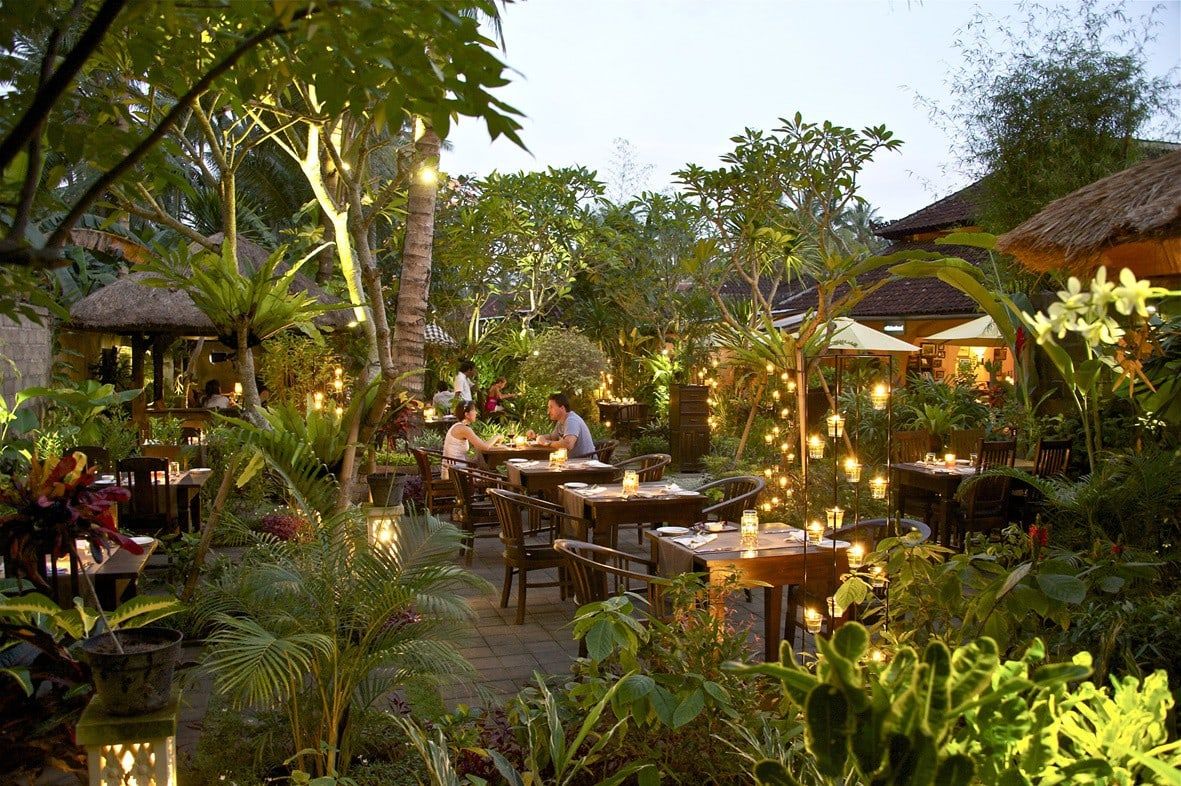 The garden courtyard at Vincent’s in Candidasa at dusk, with lanterns among the plants