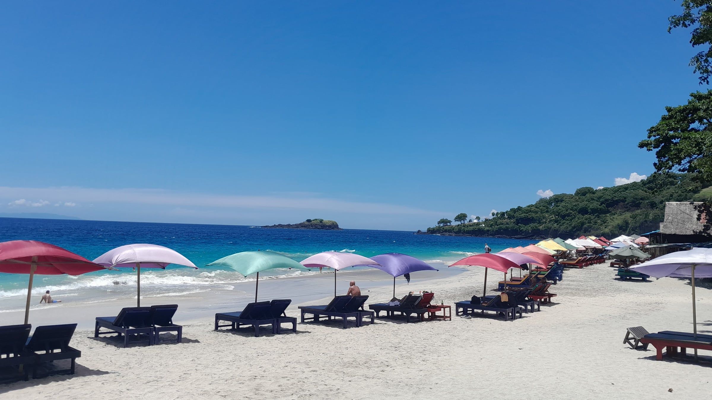 Loungers and umbrellas on the white sand of Virgin Beach